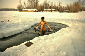 Nudist girl swimming in river in the